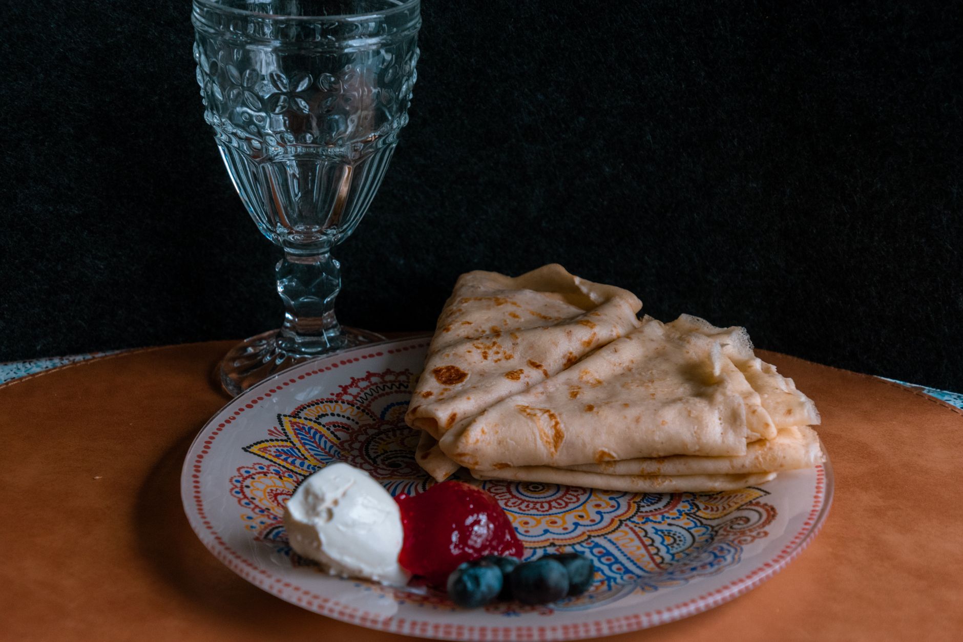 Golden crepes Suzette sizzling in pan with orange sauce