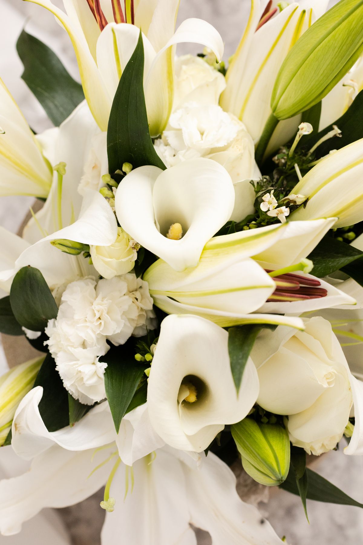 Elegant arrangement of white lilies, calla lilies, and carnations