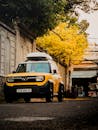 Yellow SUV on Vietnamese Street During Fall