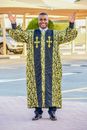 Man in Blue and Yellow Floral Long Sleeve Shirt Standing on Road