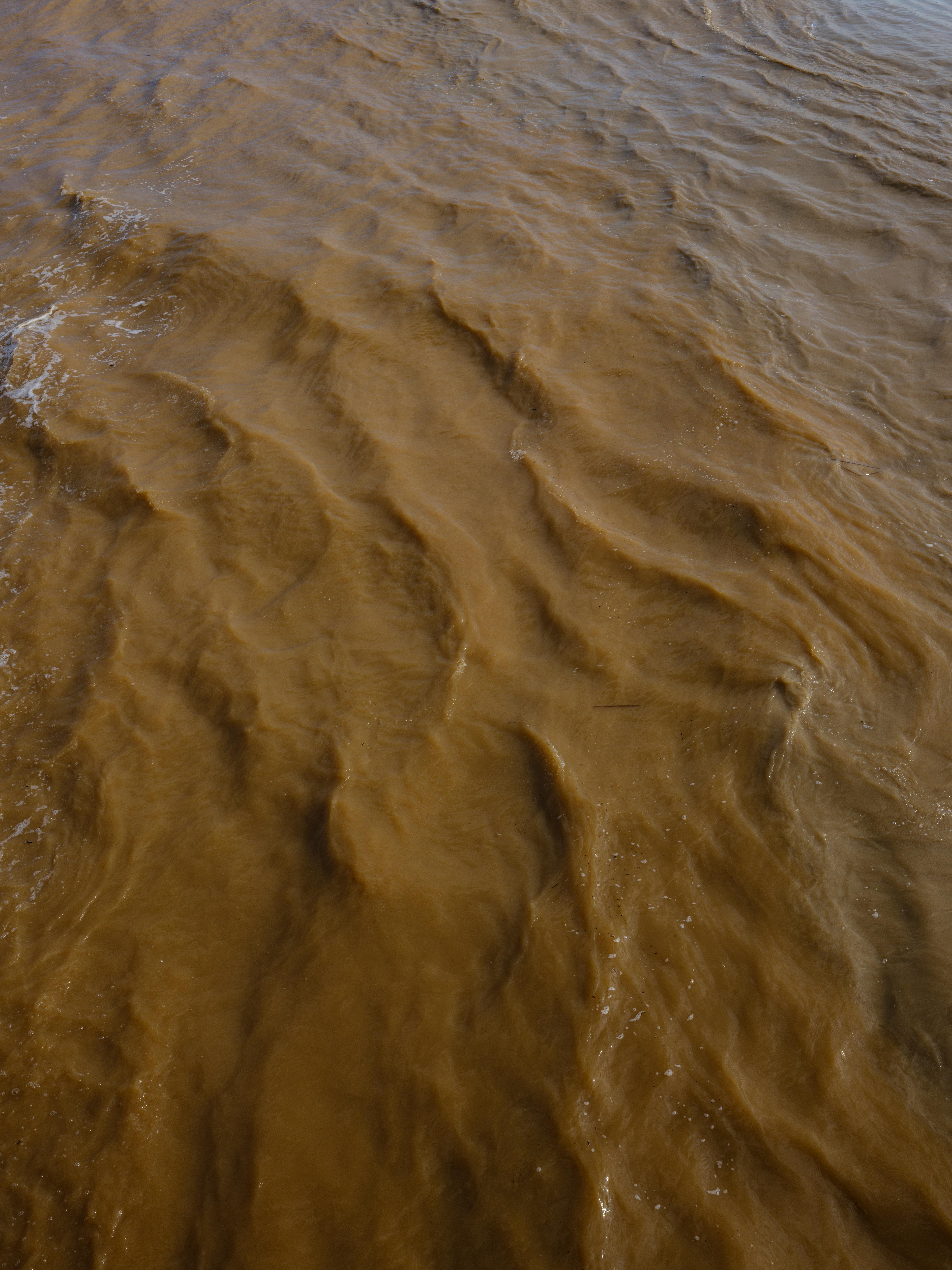 Flooded campground road near a river