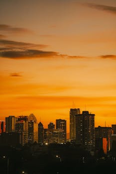 Beautiful view of Jakarta's skyline under a vibrant sunset sky.