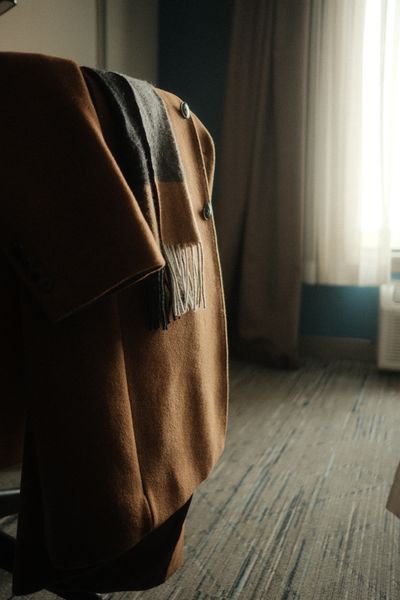 Camel wool coat with a draped cashmere scarf. Photo by Eliezer Muller on Pexels