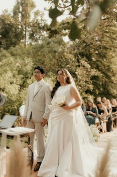 Bride and groom stand at altar during outdoor garden wedding ceremony.