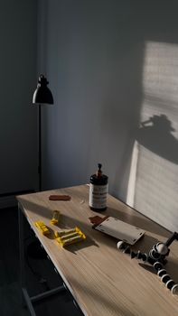 A minimalist office desk with a lamp, shadows, and assorted stationery in natural light.