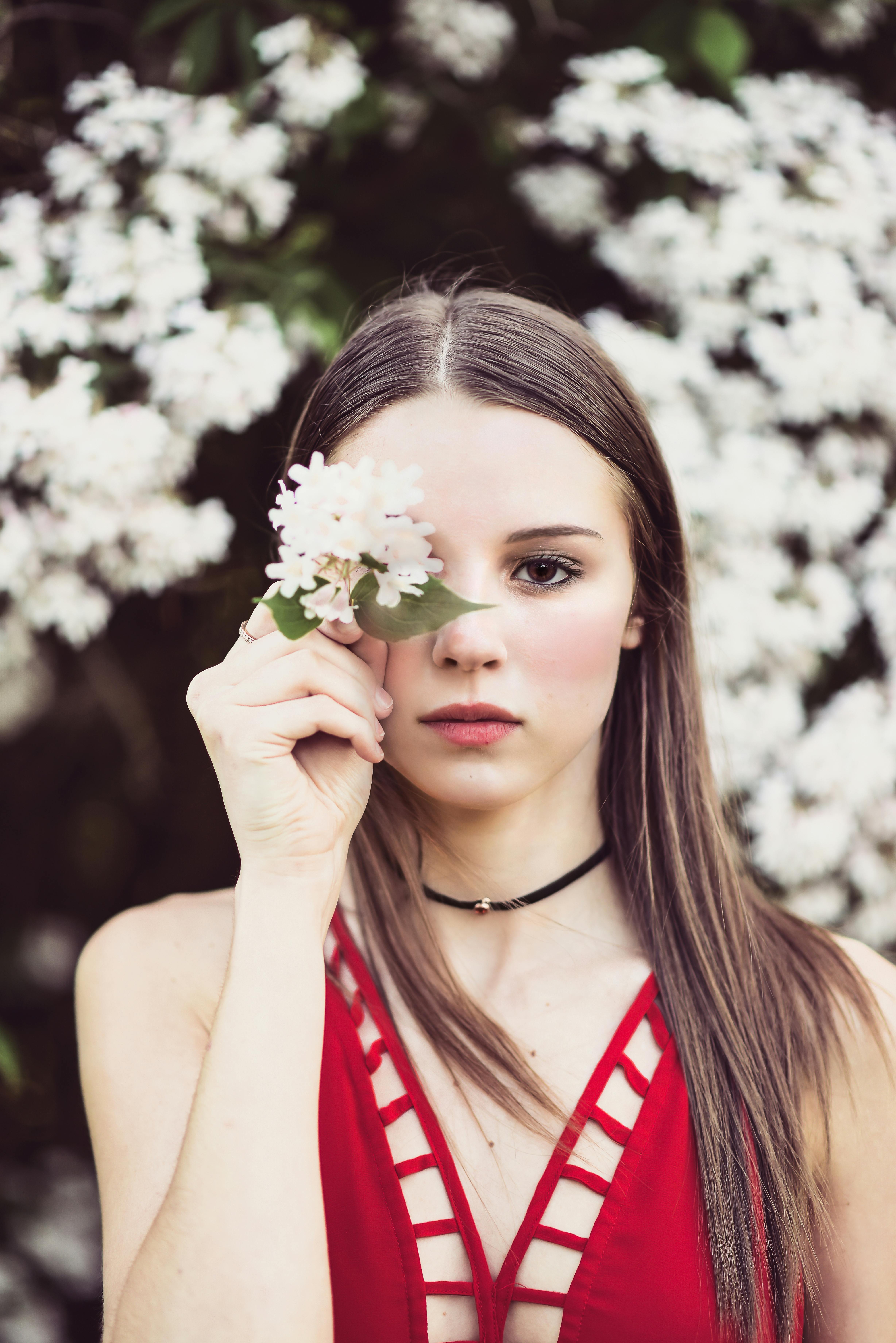 Woman in Red Tank Top Holding White Flowers · Free Stock Photo