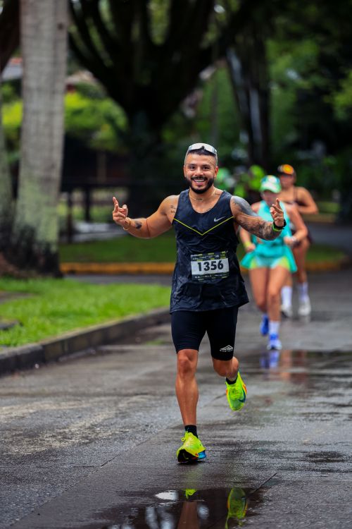 Free Smiling runner making thumbs-up gesture during a race in Risaralda, Colombia. Stock Photo