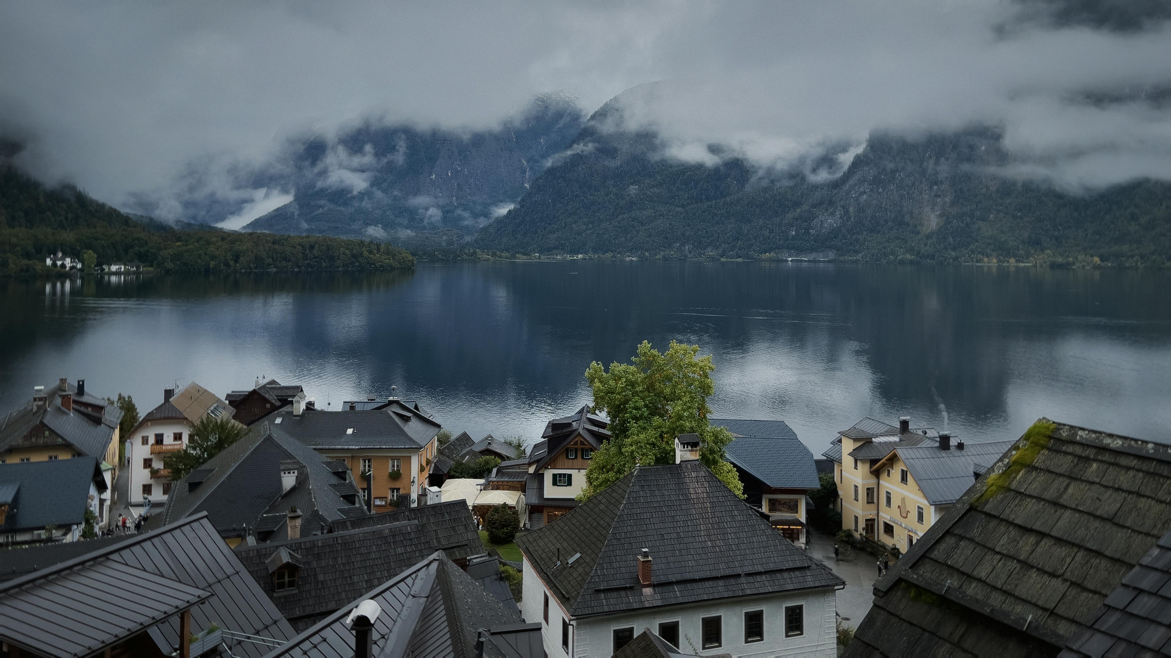 ฟรี ภาพทิวทัศน์อันงดงามของหมู่บ้านฮัลล์สตัดท์ริมทะเลสาบ โดยมีภูเขาปกคลุมด้วยหมอกเป็นฉากหลัง คลังภาพถ่าย