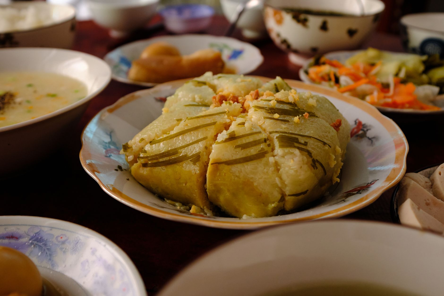 Close-up of traditional Vietnamese Banh Chung served during Tet celebrations in Bến Tre, Vietnam.