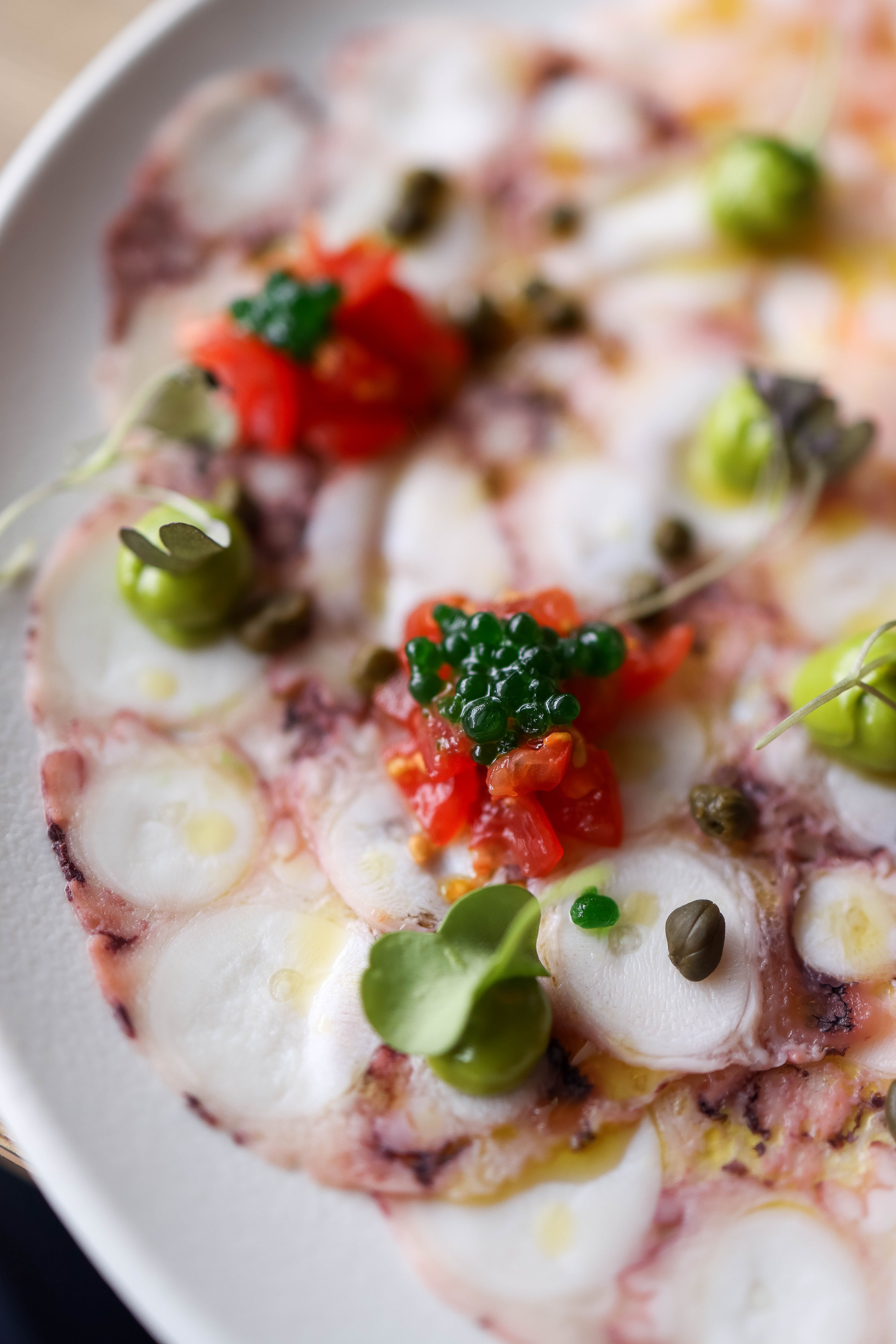 Octopus carpaccio with capers and microgreens at Lume