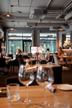 Cozy restaurant interior with elegant table setting and soft lighting, creating a warm dining atmosphere.