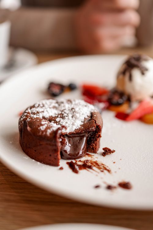 Free Tempting chocolate lava cake with ice cream and berries on a plate, perfect for dessert lovers. Stock Photo