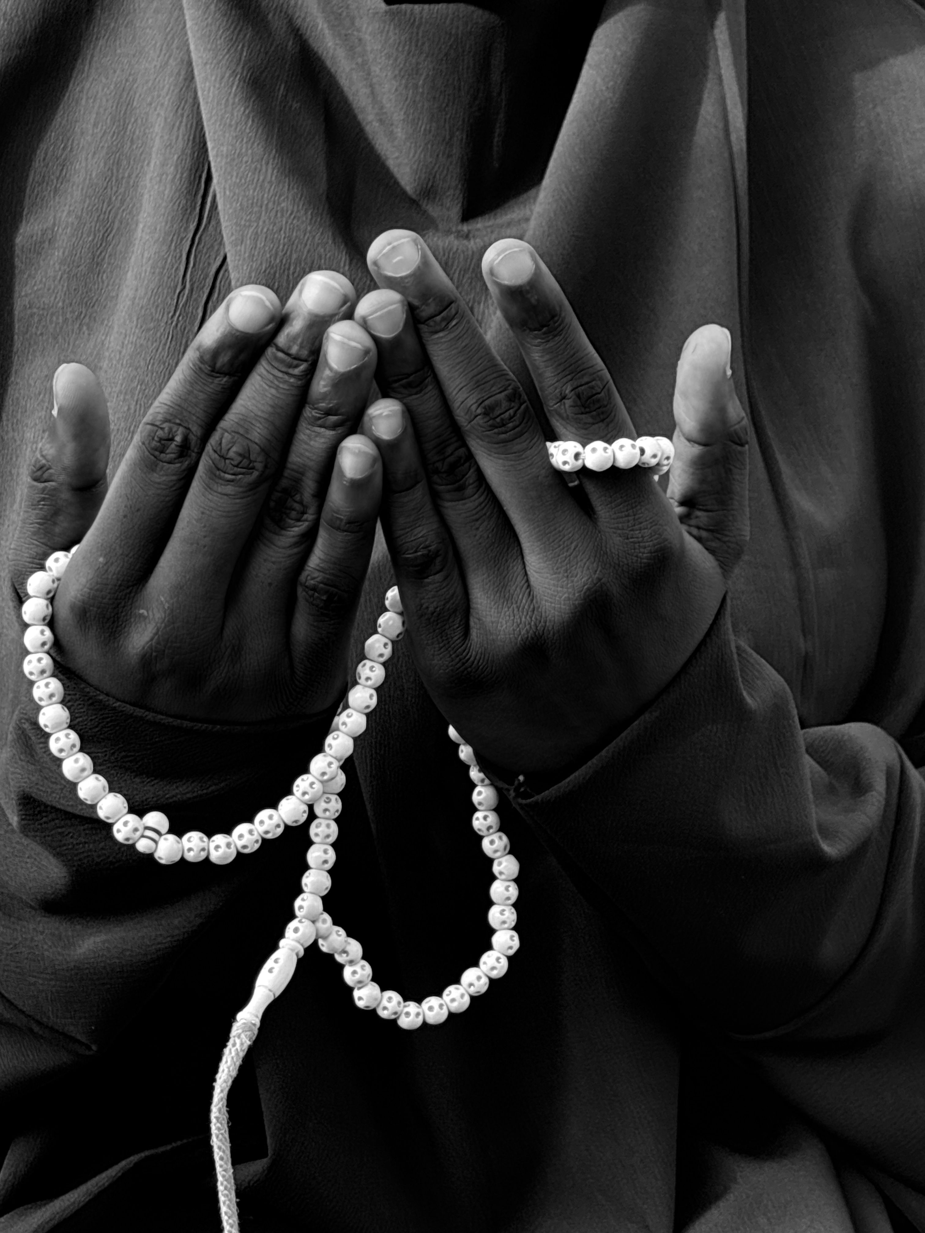 Hands Holding Prayer Beads in Black and White · Free Stock Photo