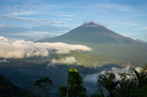 Free Stunning landscape of Mount Agung with lush greenery and clouds in Bali, Indonesia. Stock Photo