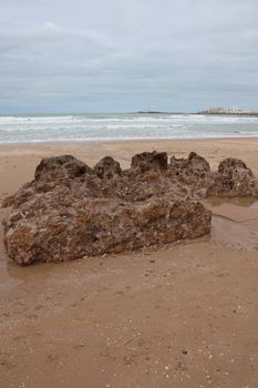 Explore the unique rock formations on Cádiz's picturesque beach, capturing Spain's coastal charm.