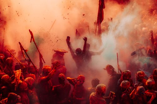 Free Colorful Holi celebration with people covered in powders and smoke in India. Stock Photo