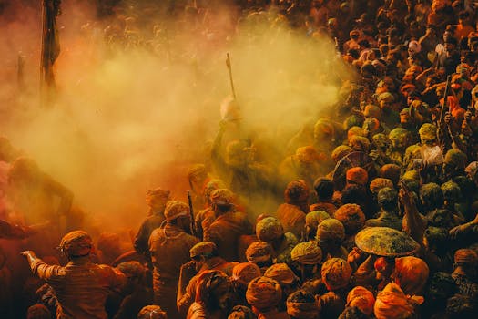 Crowd celebrating the colorful Holi festival with vibrant powder and joy.