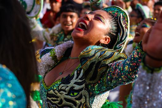 Vibrant street festival in Arica, Chile with colorful costumes and joyful expressions.