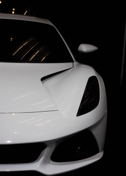 Free Close-up of a sleek white sports car with focus on the headlight and aerodynamic design. Stock Photo