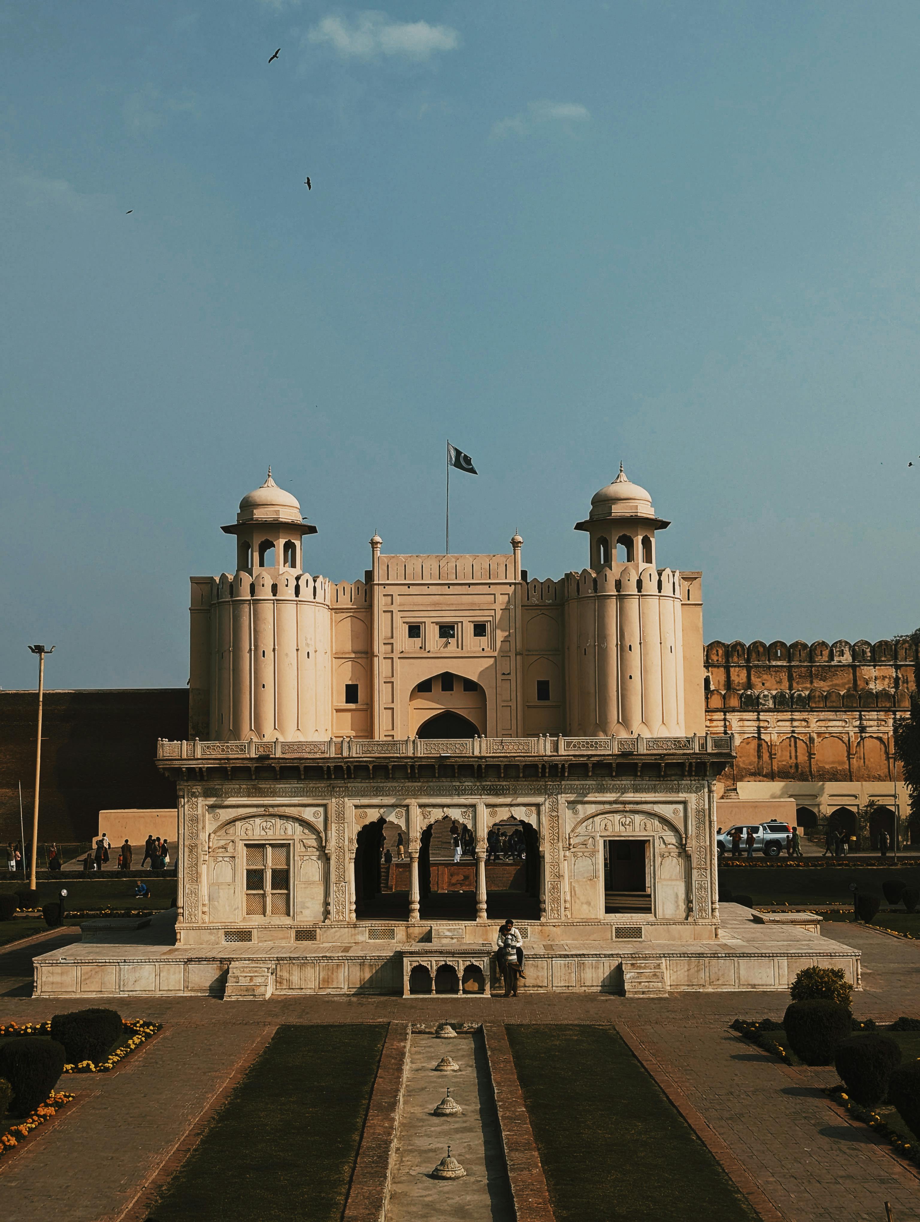 Lahore Fort's grand architecture stands tall under a clear sky, capturing history and elegance.