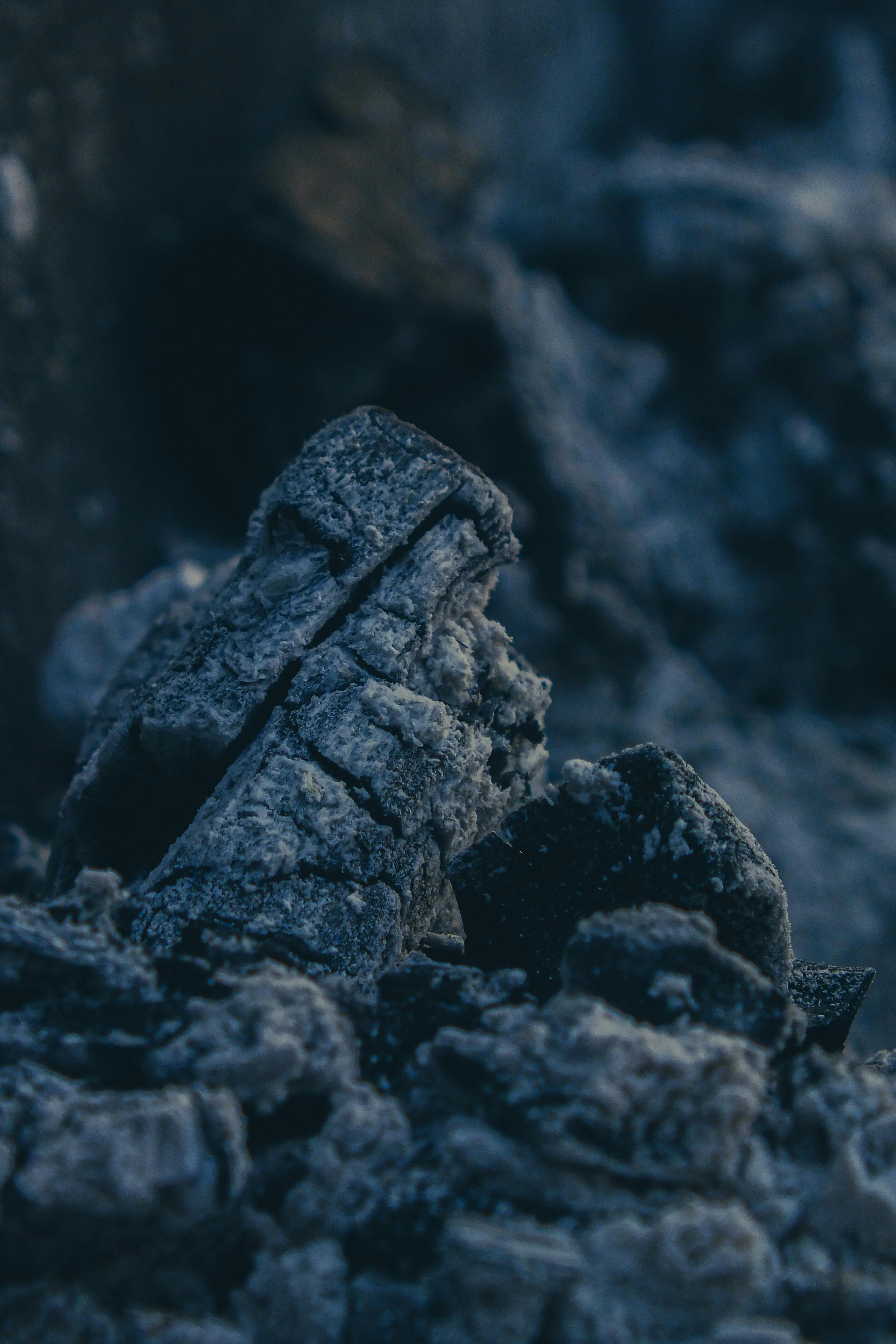 Free Detailed close-up of charcoal ash with deep blue hues creating a moody, textured scene. Stock Photo
