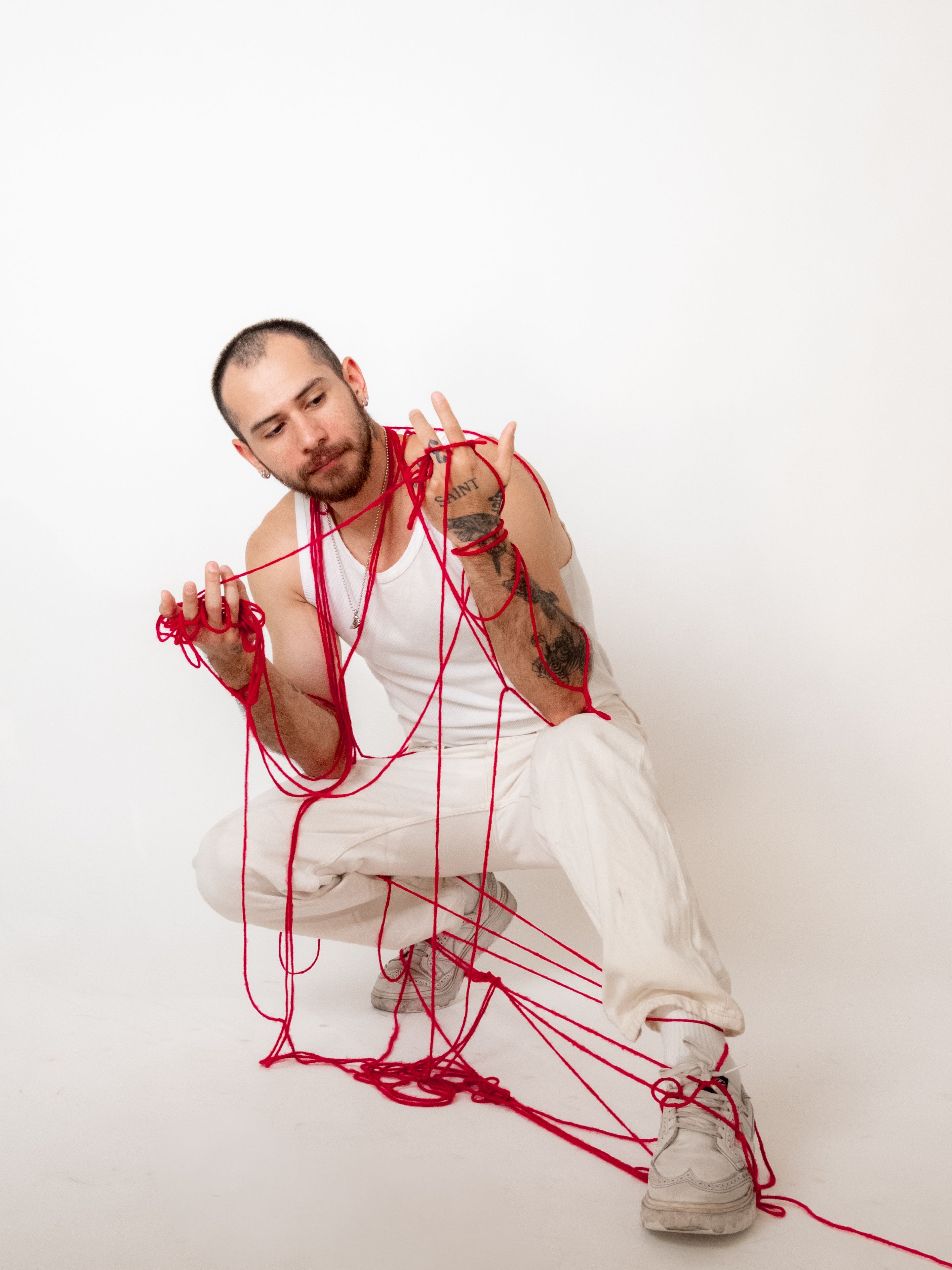 Man Tangled in Red Thread in Studio Portrait · Free Stock Photo