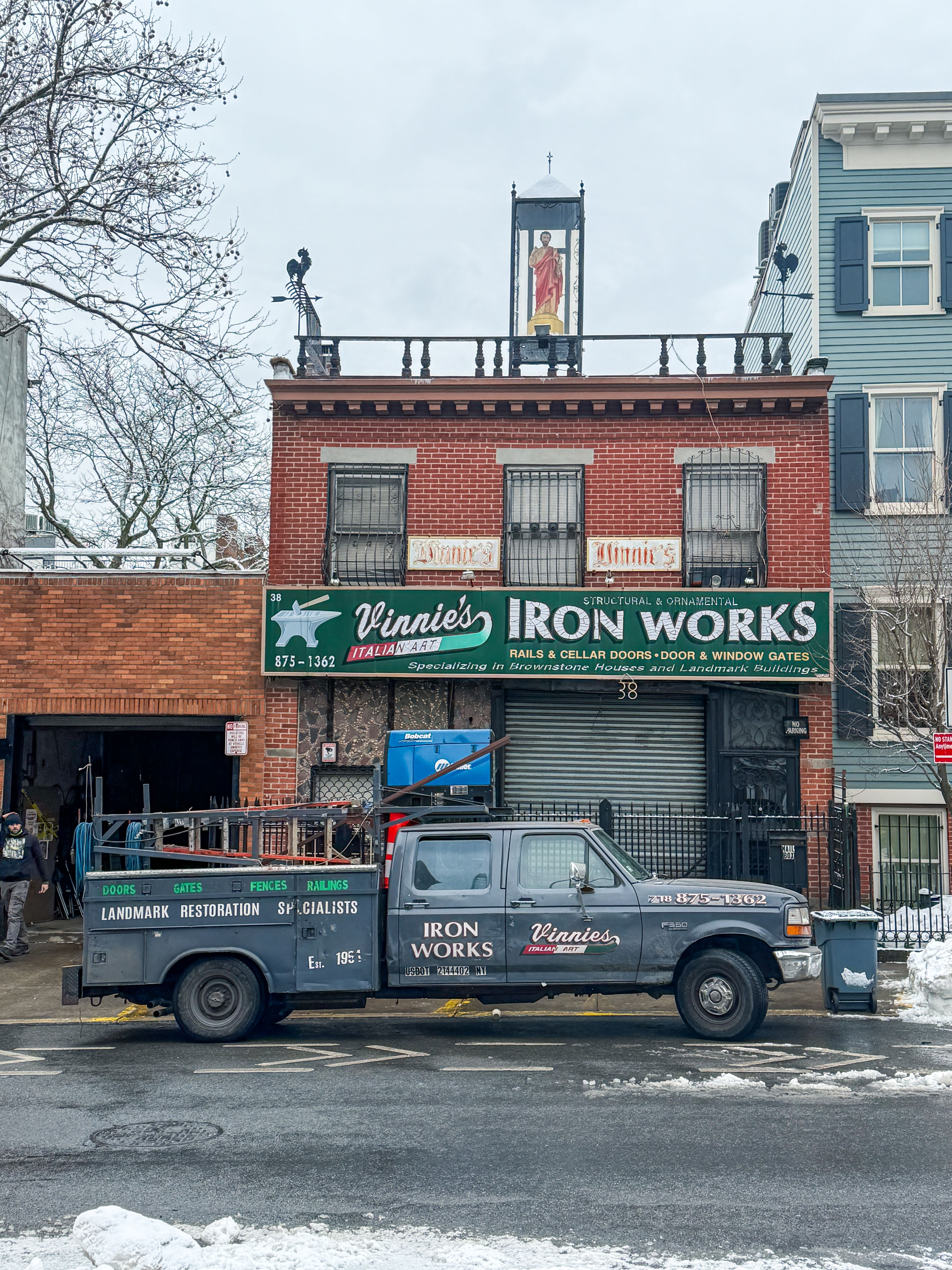 Front view of Vinnie's Iron Works with truck in wintertime Brooklyn, NY.
