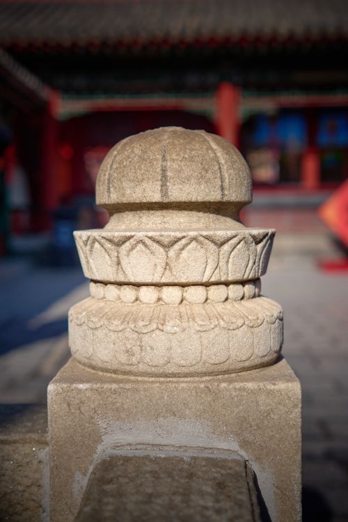 Free Close-up of a decorative stone carving in a traditional Chinese architectural setting. Stock Photo