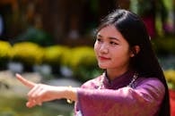 Young Woman in Traditional Outfit Smiling Outdoors