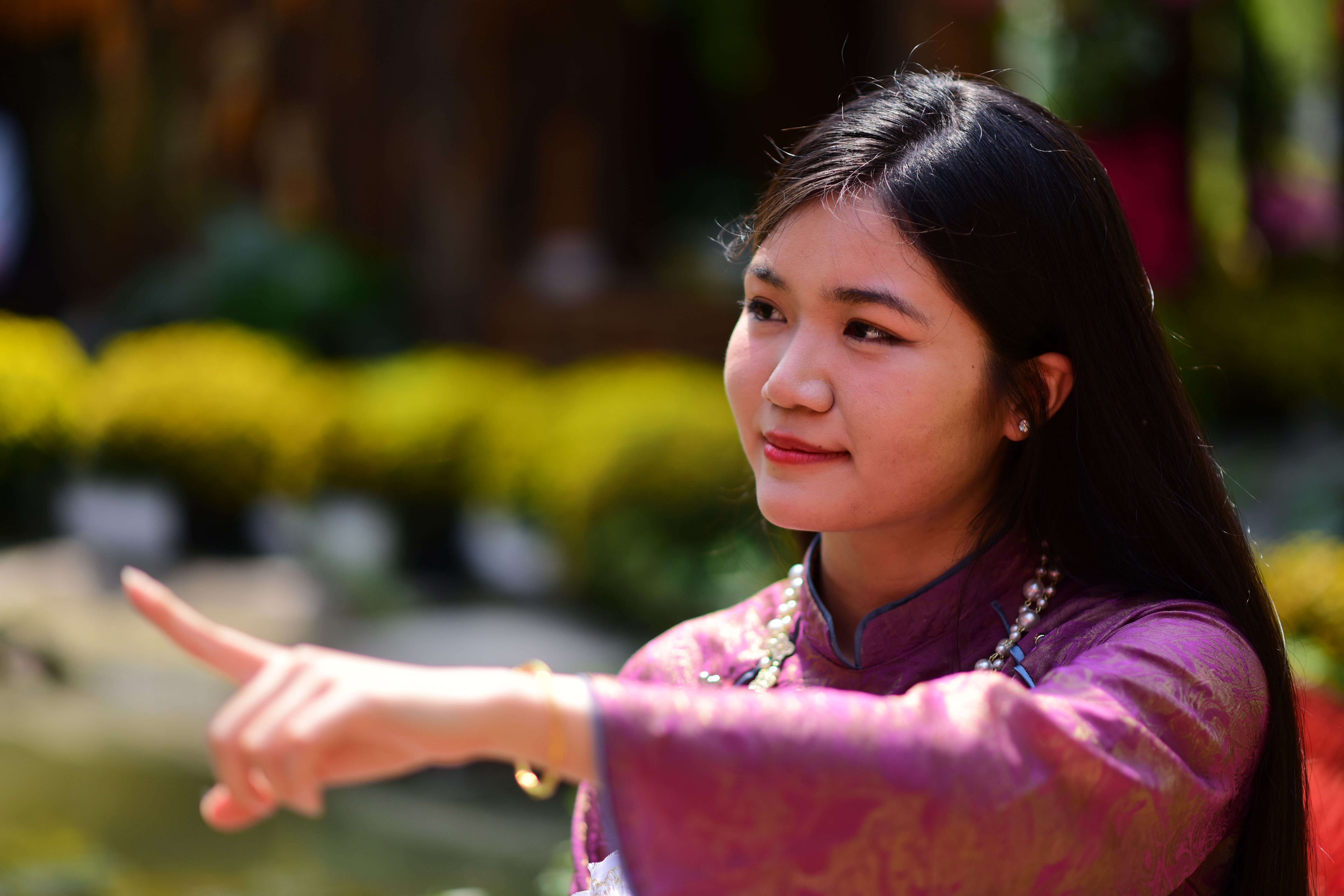 Young Woman in Traditional Outfit Smiling Outdoors · Free Stock Photo