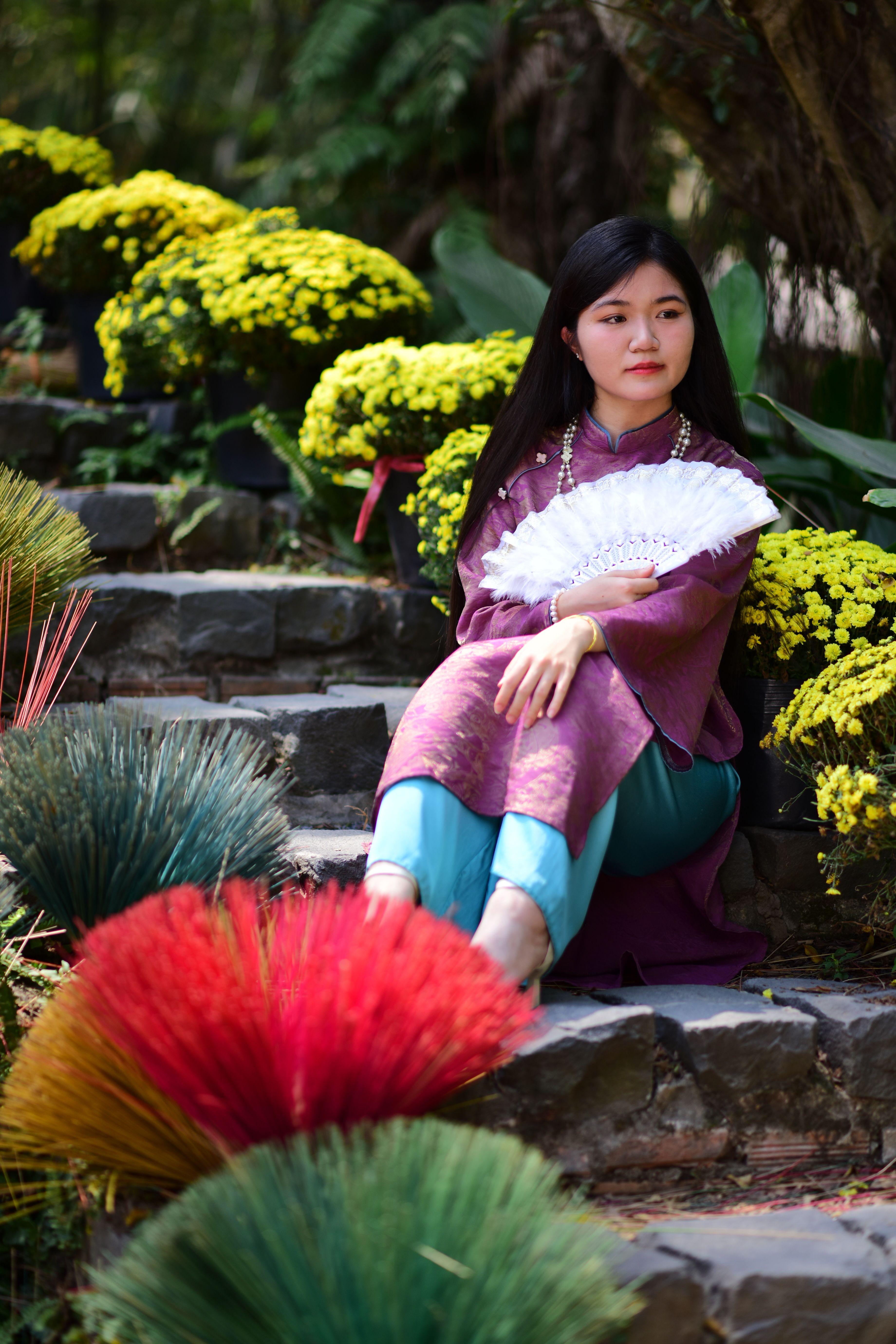 Woman in Traditional Dress Amongst Vibrant Flowers · Free Stock Photo
