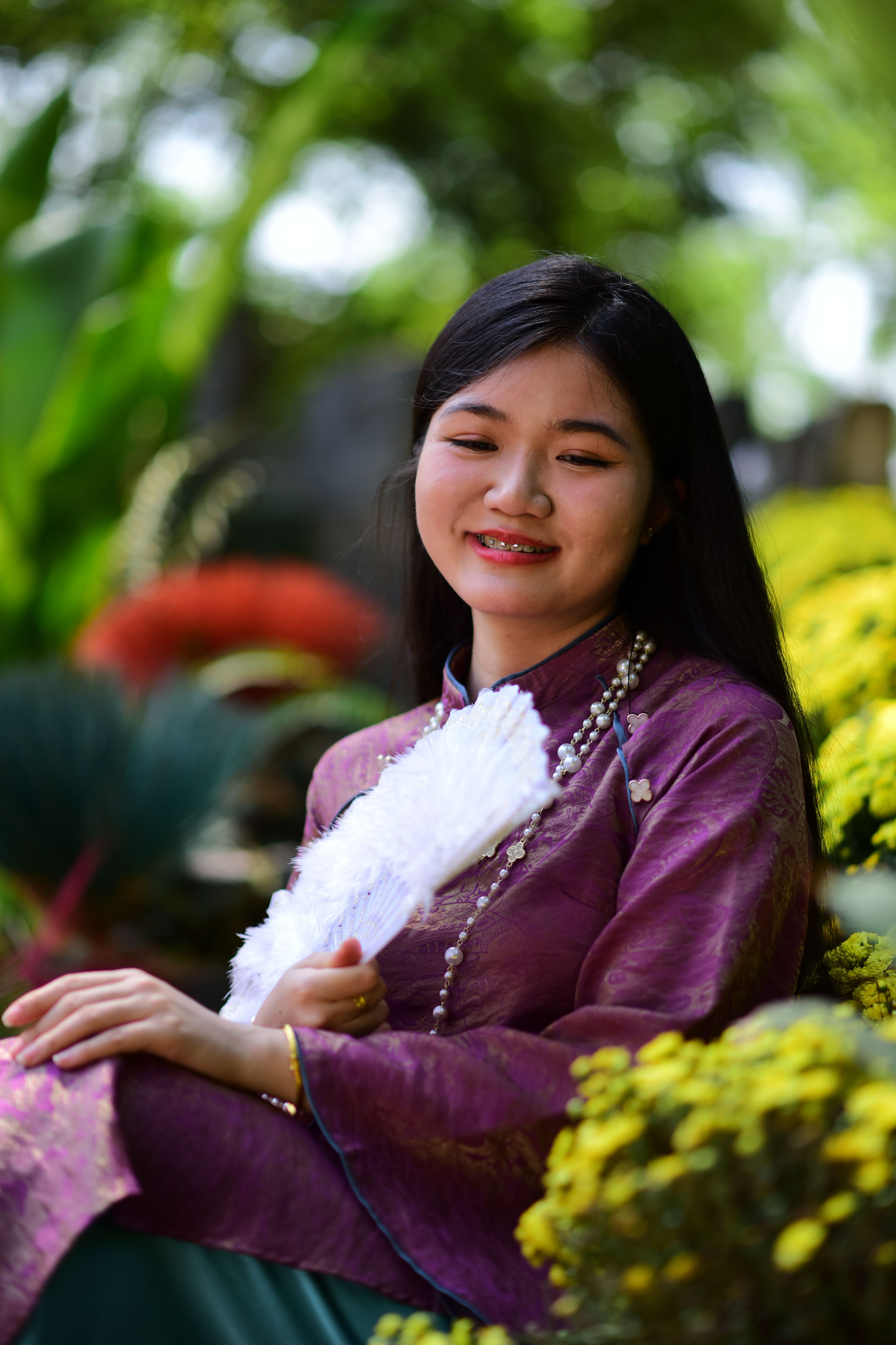 Young Woman in Traditional Attire Smiling Outdoors · Free Stock Photo