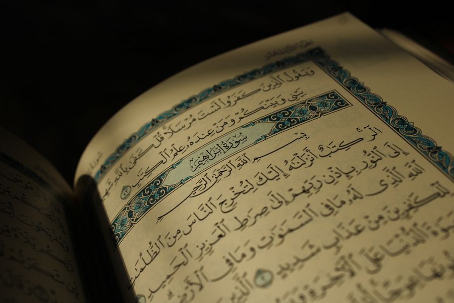 Open Quran with Arabic calligraphy and Tajweed verses