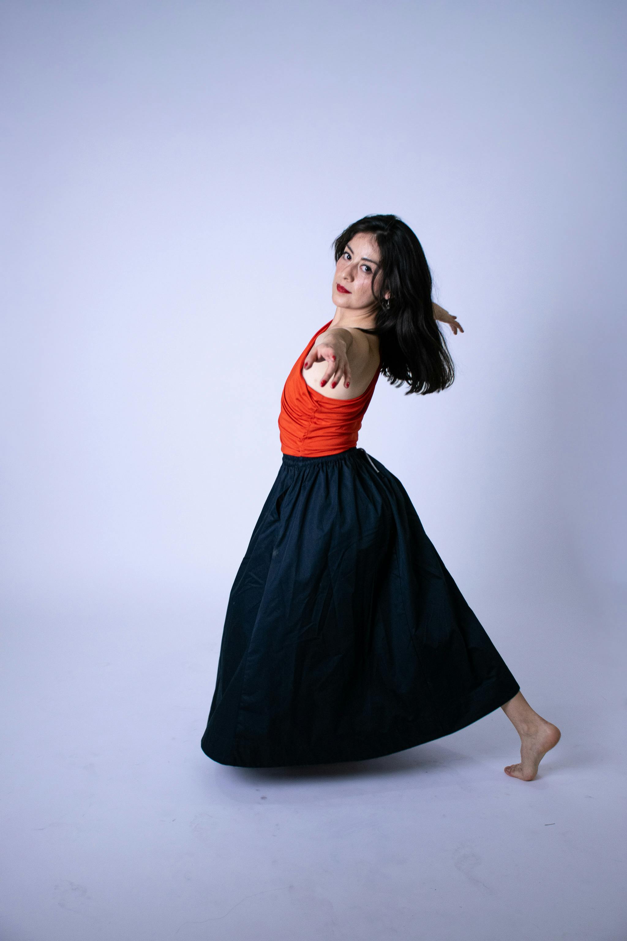 Free Graceful dancer in vibrant attire showcasing fluid movement in a minimalist setting. Stock Photo