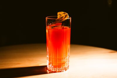 A citrus-garnished cocktail on a wooden table — photo by Szymon Shields on Pexels