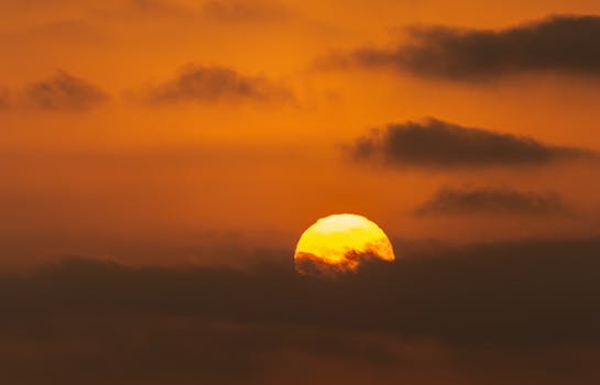 A stunning sunset with an orange sky and dramatic clouds capturing nature's beauty.