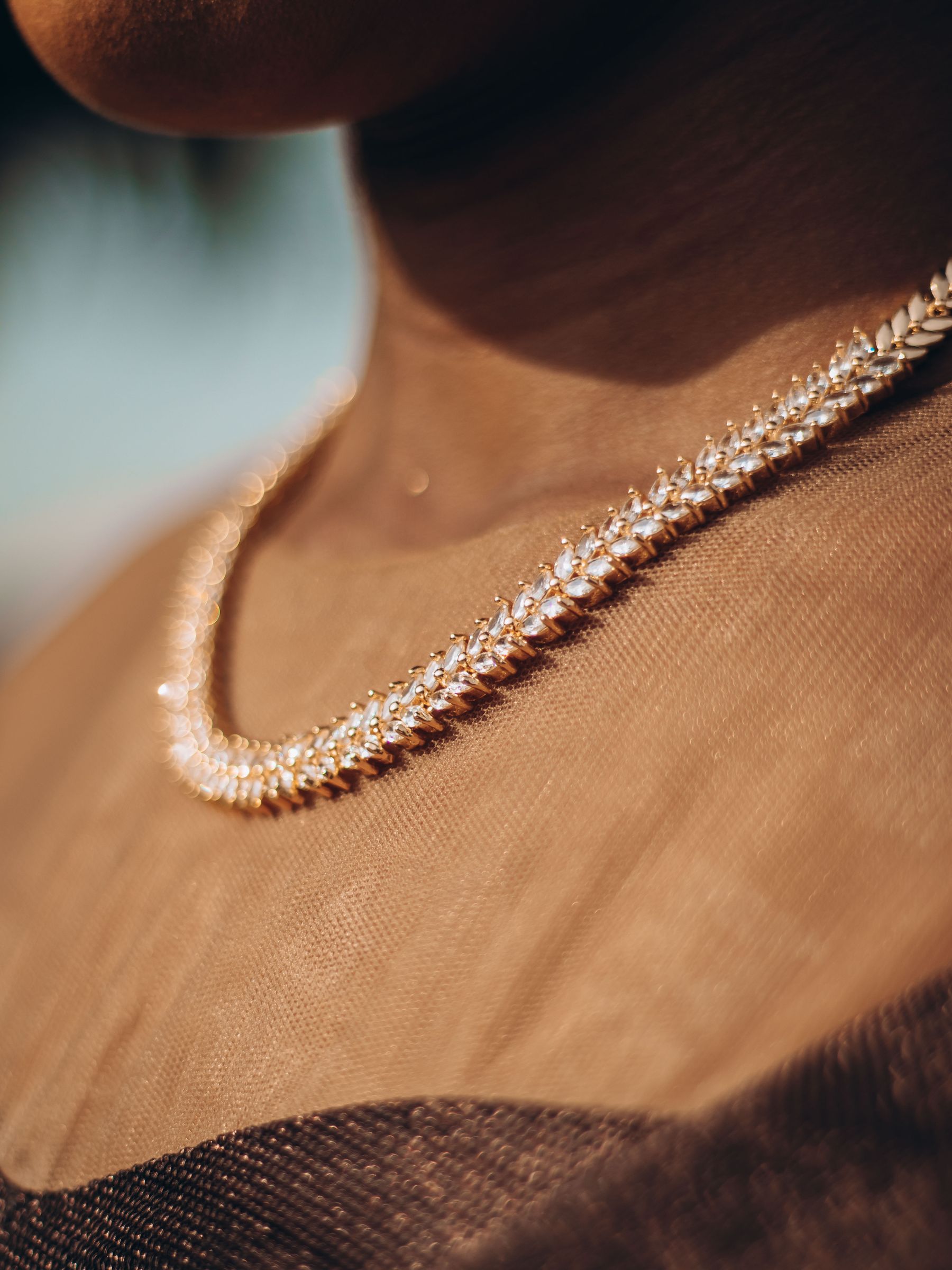A diamond necklace worn at the collarbone