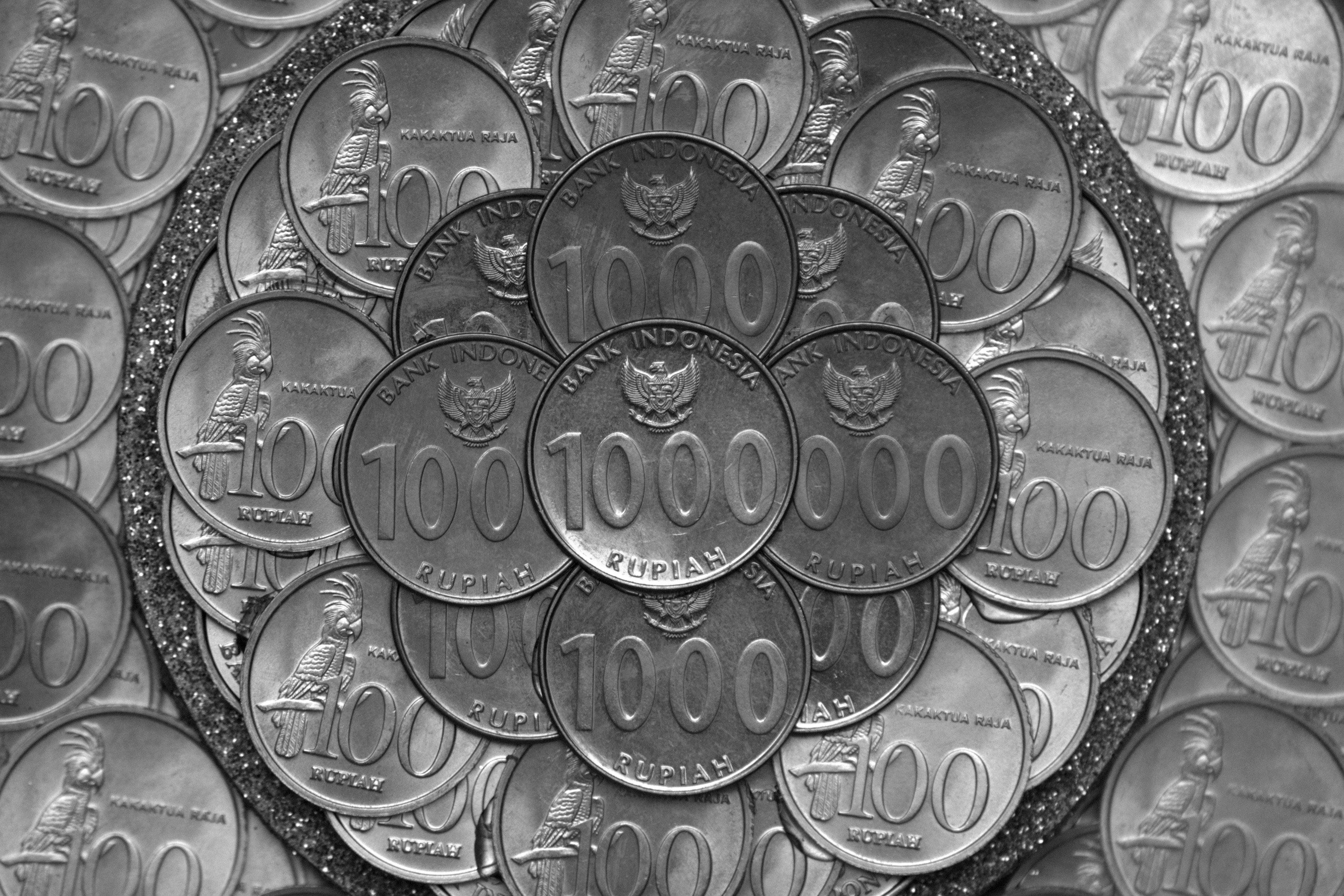Free Close-up of 1000 Rupiah coins showcasing Indonesian culture and currency details. Stock Photo