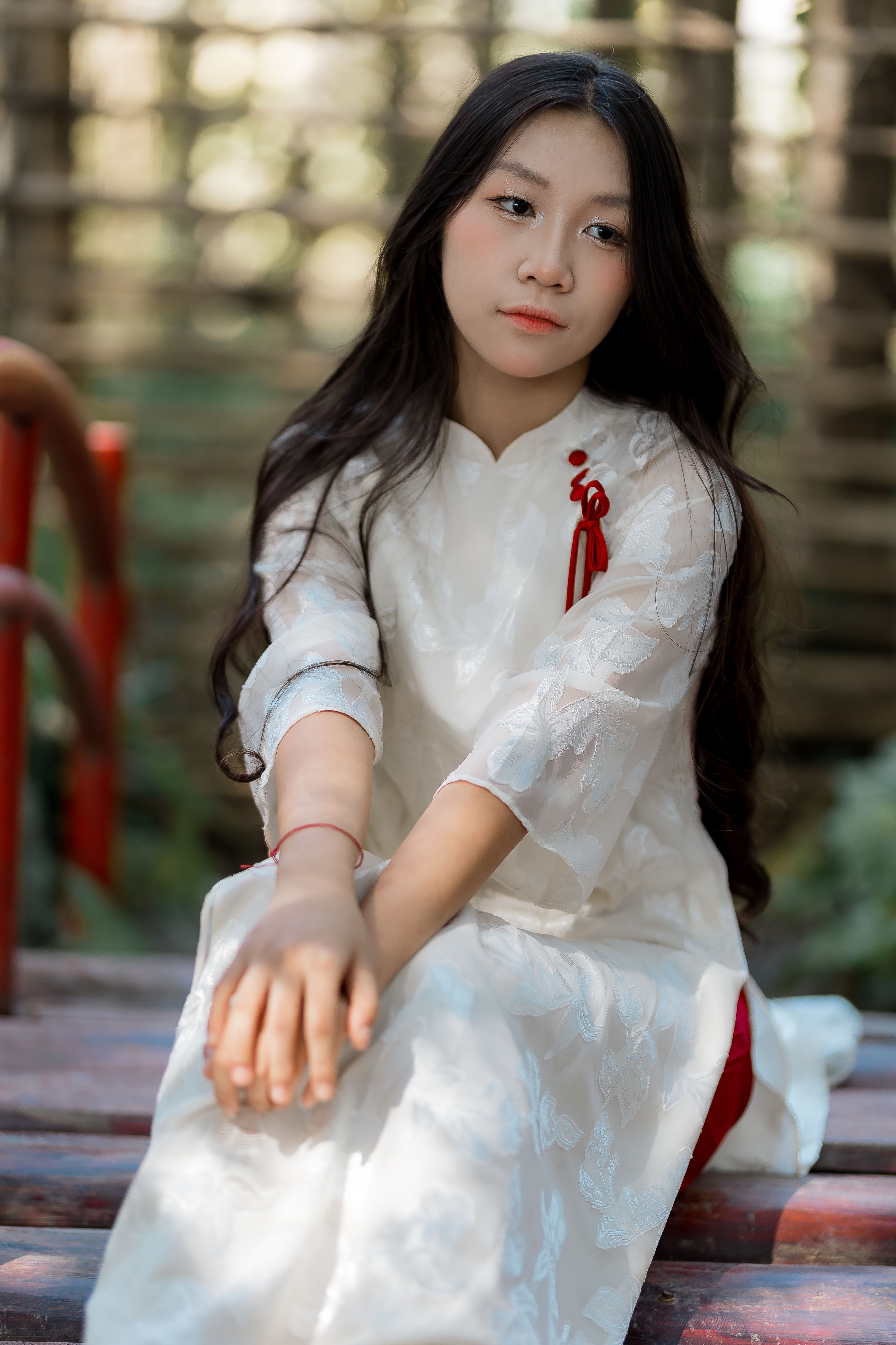 Young Woman in Traditional Dress on Steps Outdoors · Free Stock Photo
