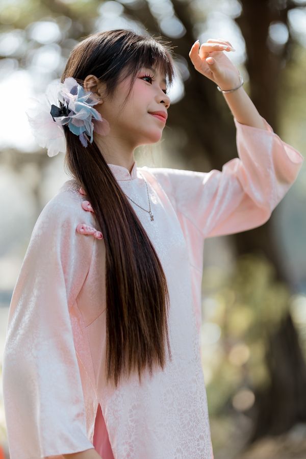 Young Girl in Traditional Pink Attire Outdoors · Free Stock Photo