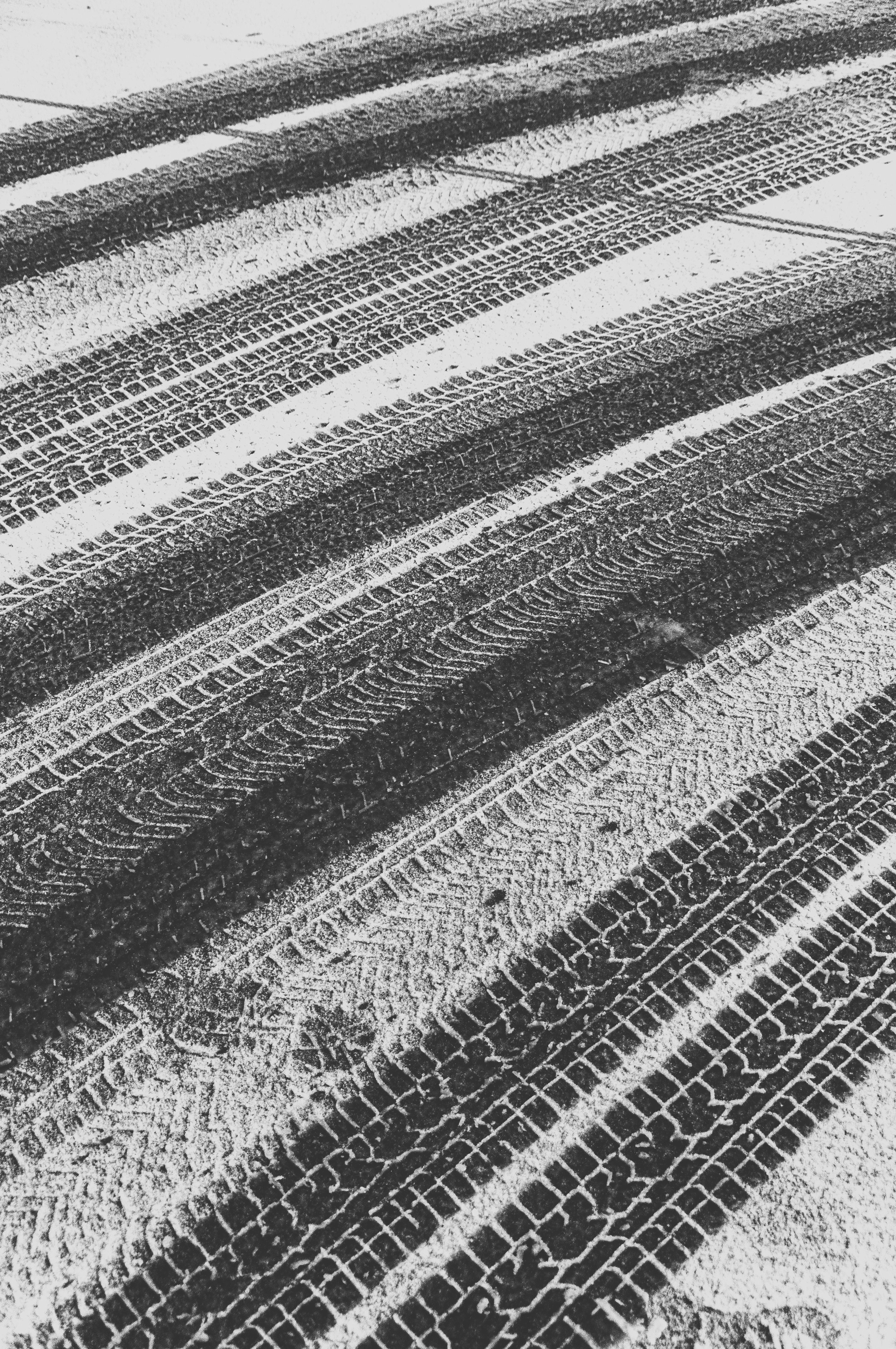 Black and White Tire Tracks on Snowy Road · Free Stock Photo
