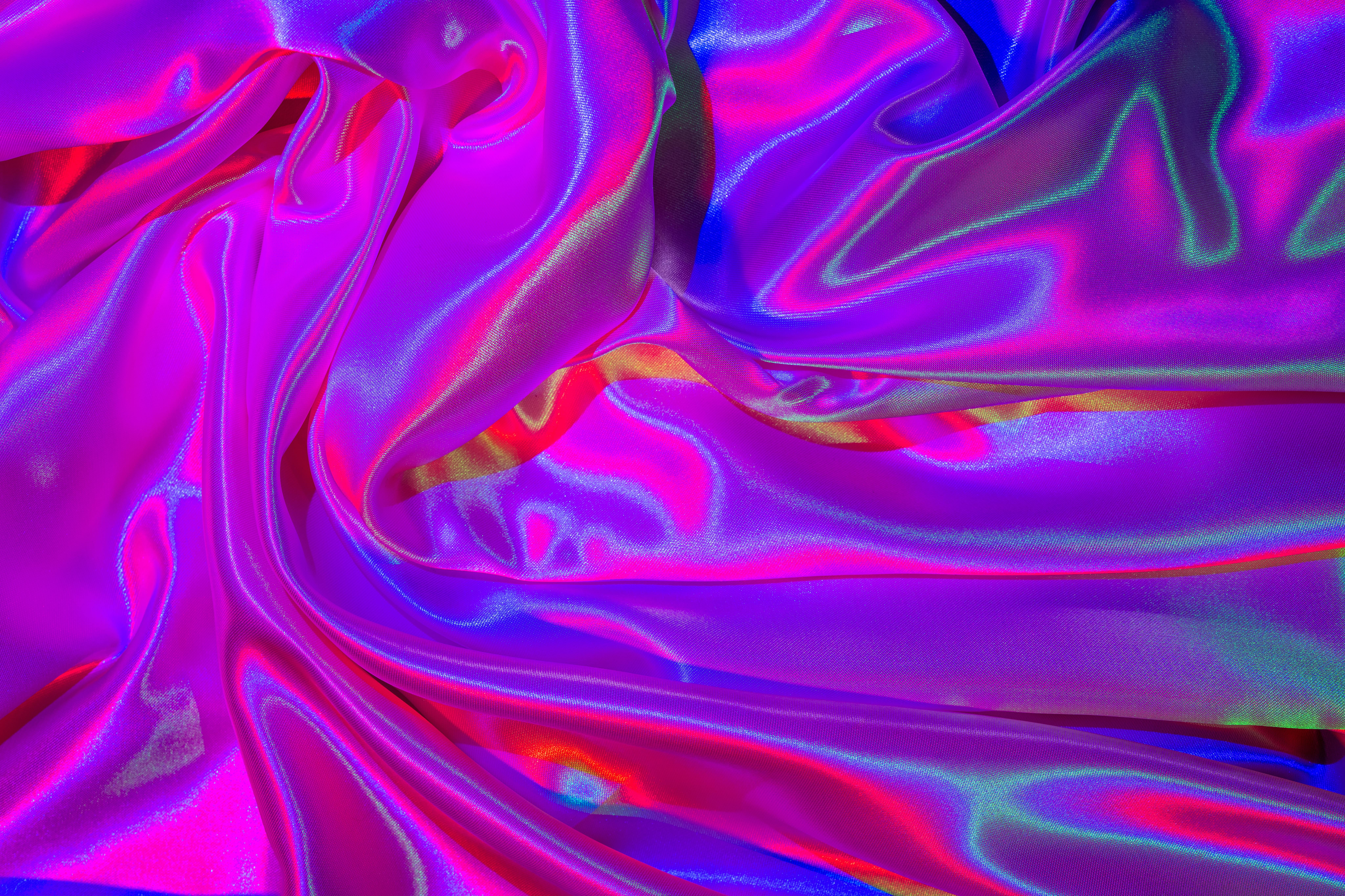 gratis Heldere en kleurrijke satijnen stof met iriserende lichteffecten, perfect voor digitale achtergronden. Stockfoto
