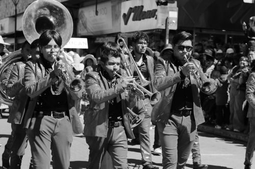 Free A lively street parade featuring a brass band performing on a sunny day. Stock Photo