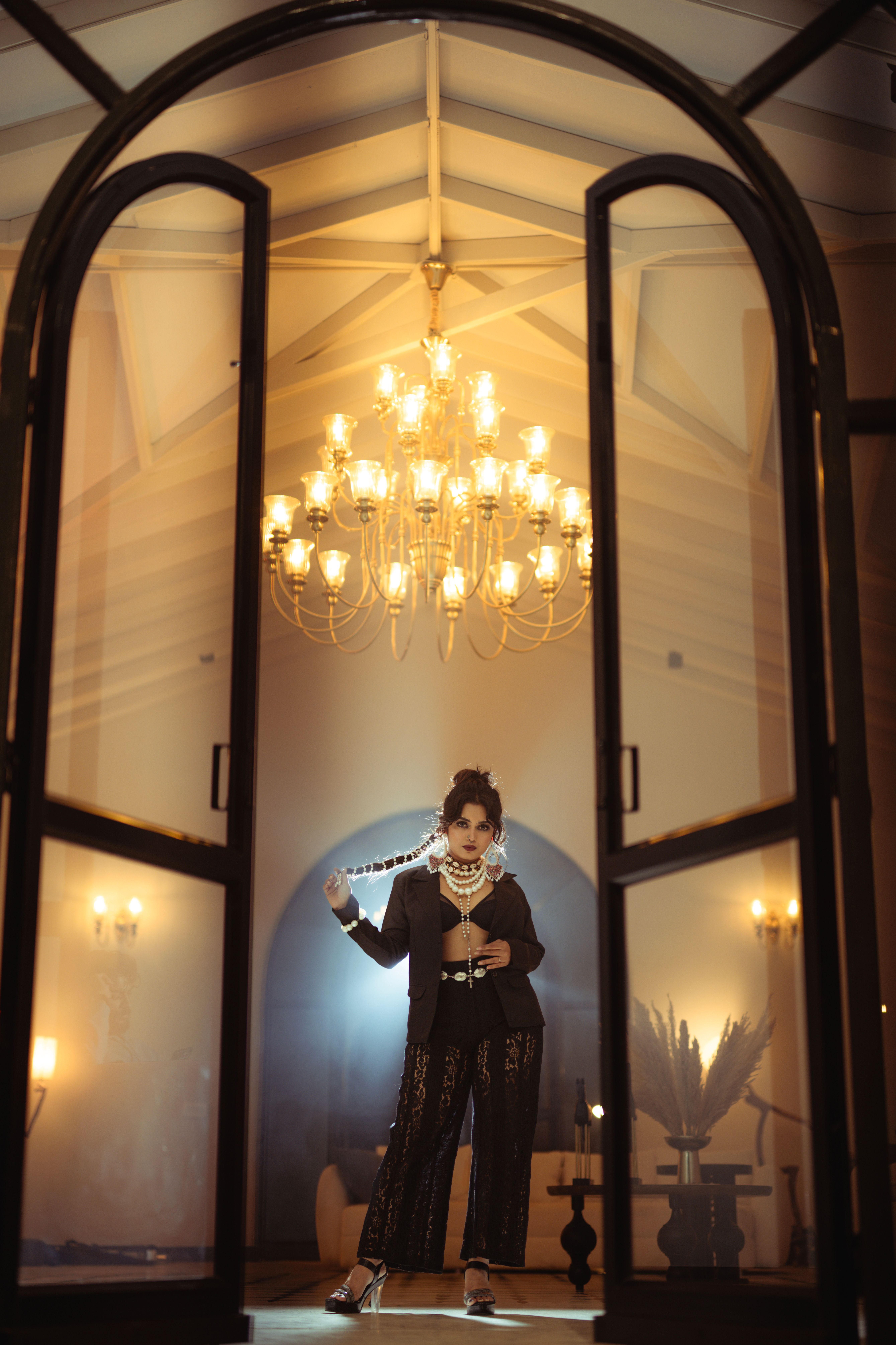 Elegant Woman Posing Indoors with Chandelier · Free Stock Photo