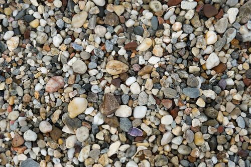 Free Close-up of colorful pebbles and stones creating a natural textured background for design use. Stock Photo