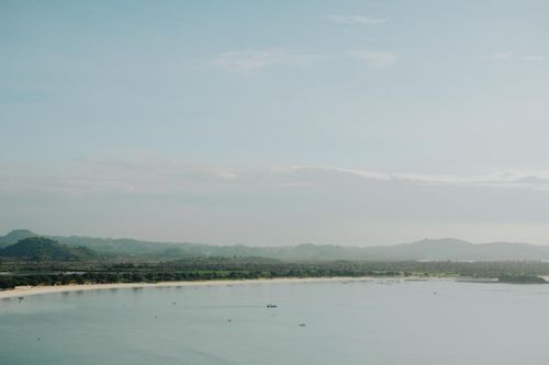 Free Tranquil coastal scene featuring mountains, calm sea, and serene landscape. Stock Photo