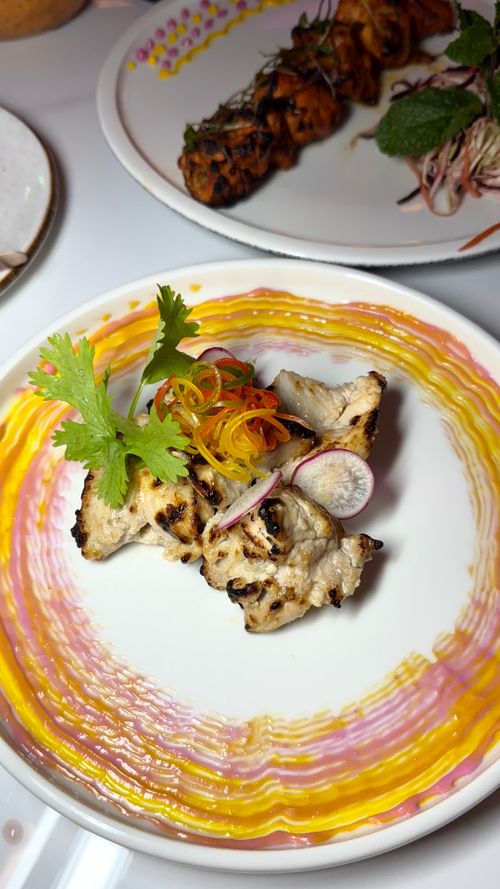 Free Grilled chicken elegantly plated with colorful veggies. A culinary delight for food enthusiasts. Stock Photo