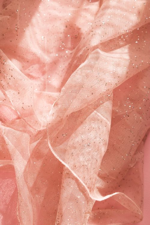 Free Close-up view of shimmering pink fabric with glitter, showcasing detailed textures and folds. Stock Photo