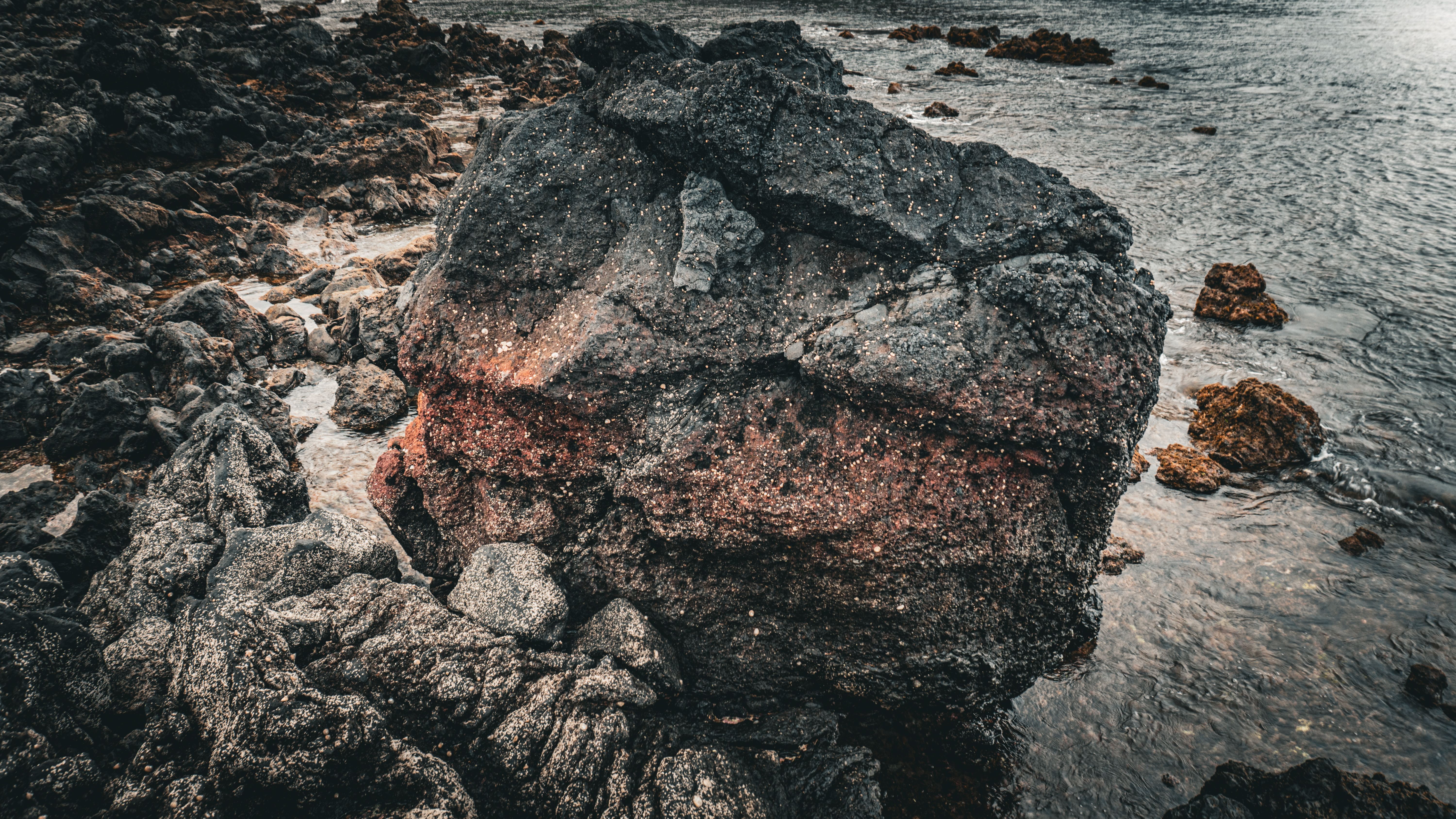 Large Volcanic Rock by Ocean Shore · Free Stock Photo