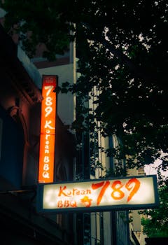 Illuminated Korean BBQ sign captured at twilight on a Melbourne street.